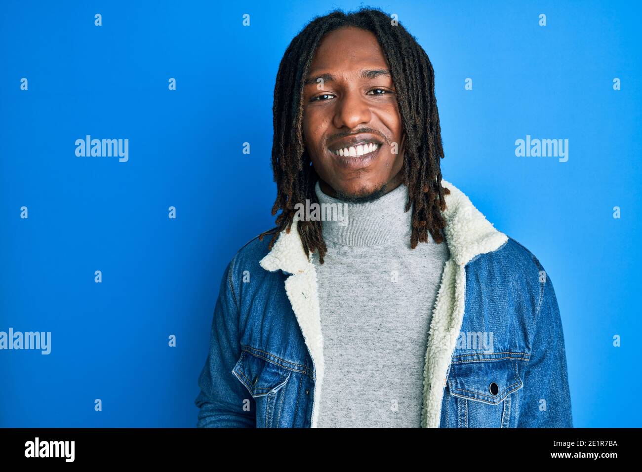 African american man with braids wearing casual denim jacket looking ...