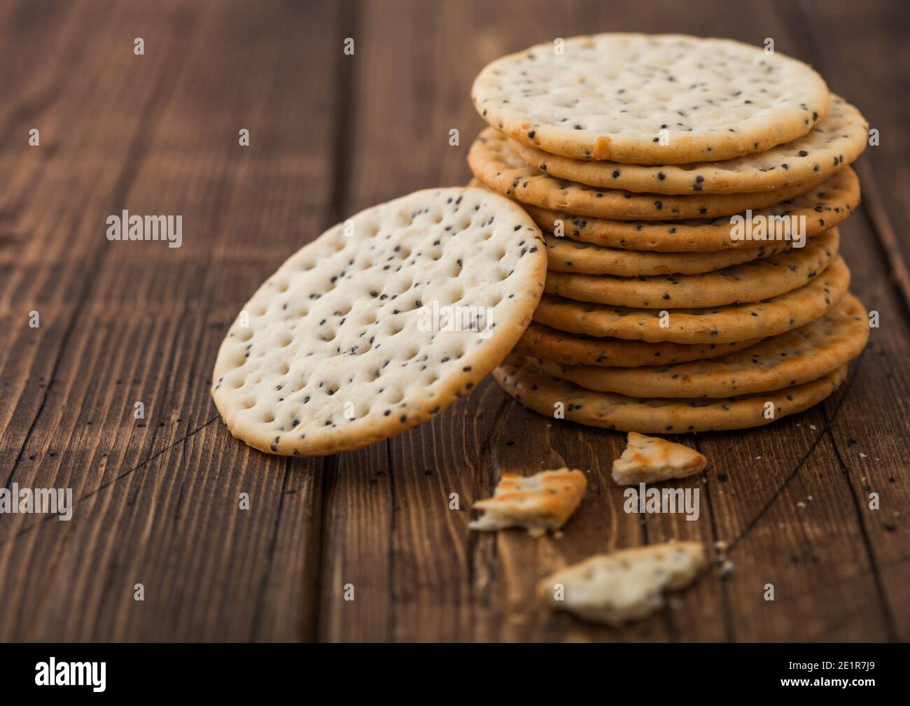 Stack of various organic crispy wheat flatbread crackers with sesame