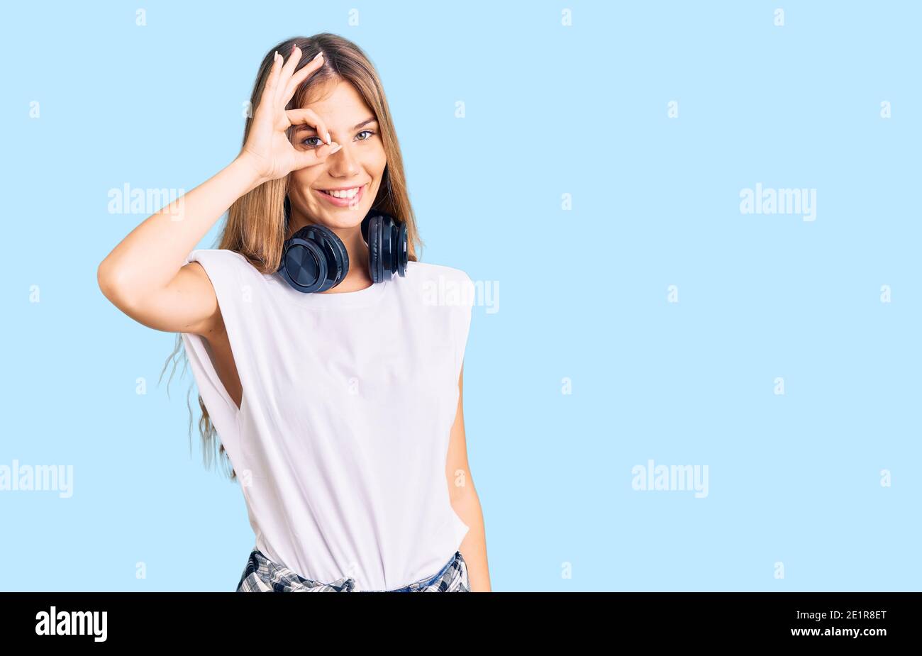 Beautiful caucasian woman with blonde hair listening to music wearing ...