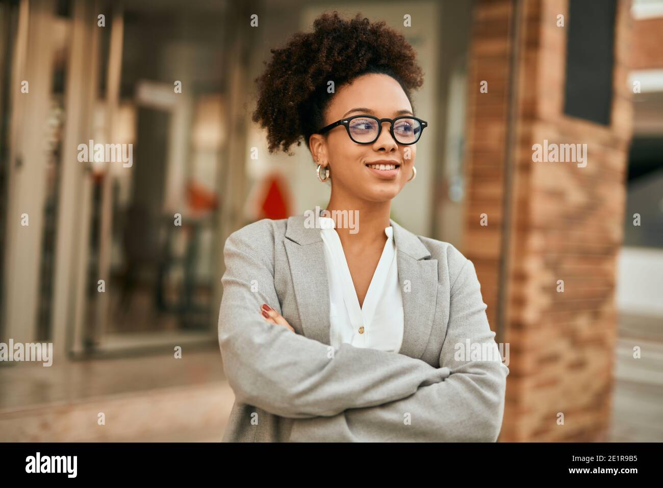 Young african american businesswoman with arms crossed standing at the ...
