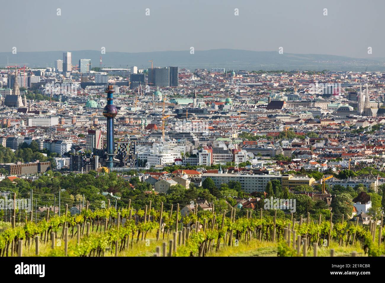 View from a hill to the city center of Vienna with the tower of the waste incineration plant Spittelau and several churches in Austria. Stock Photo