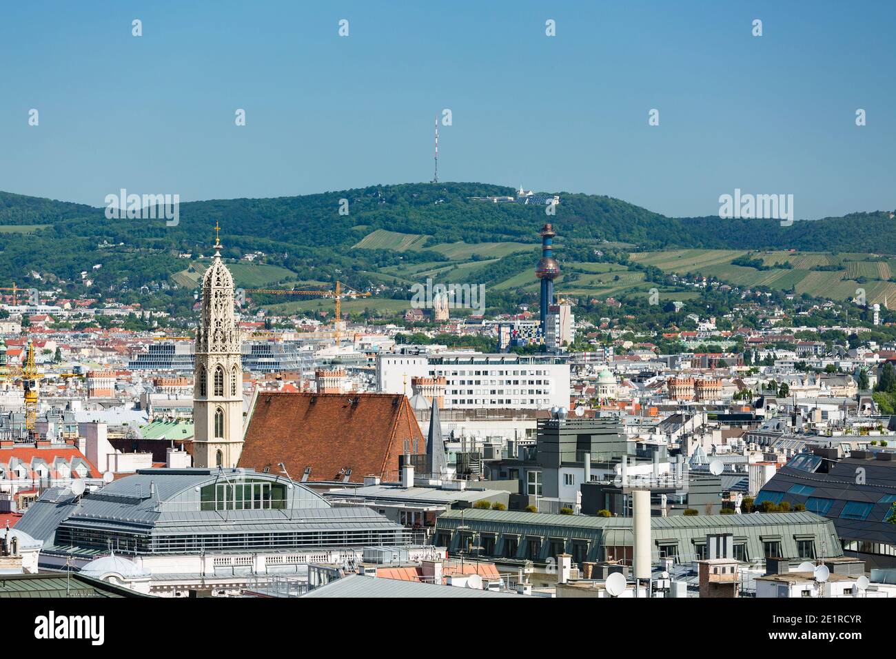 View from a church tower over the city center of Vienna with the tower of the waste incineration plant Spittelau and the Kahlenberg in the background, Stock Photo