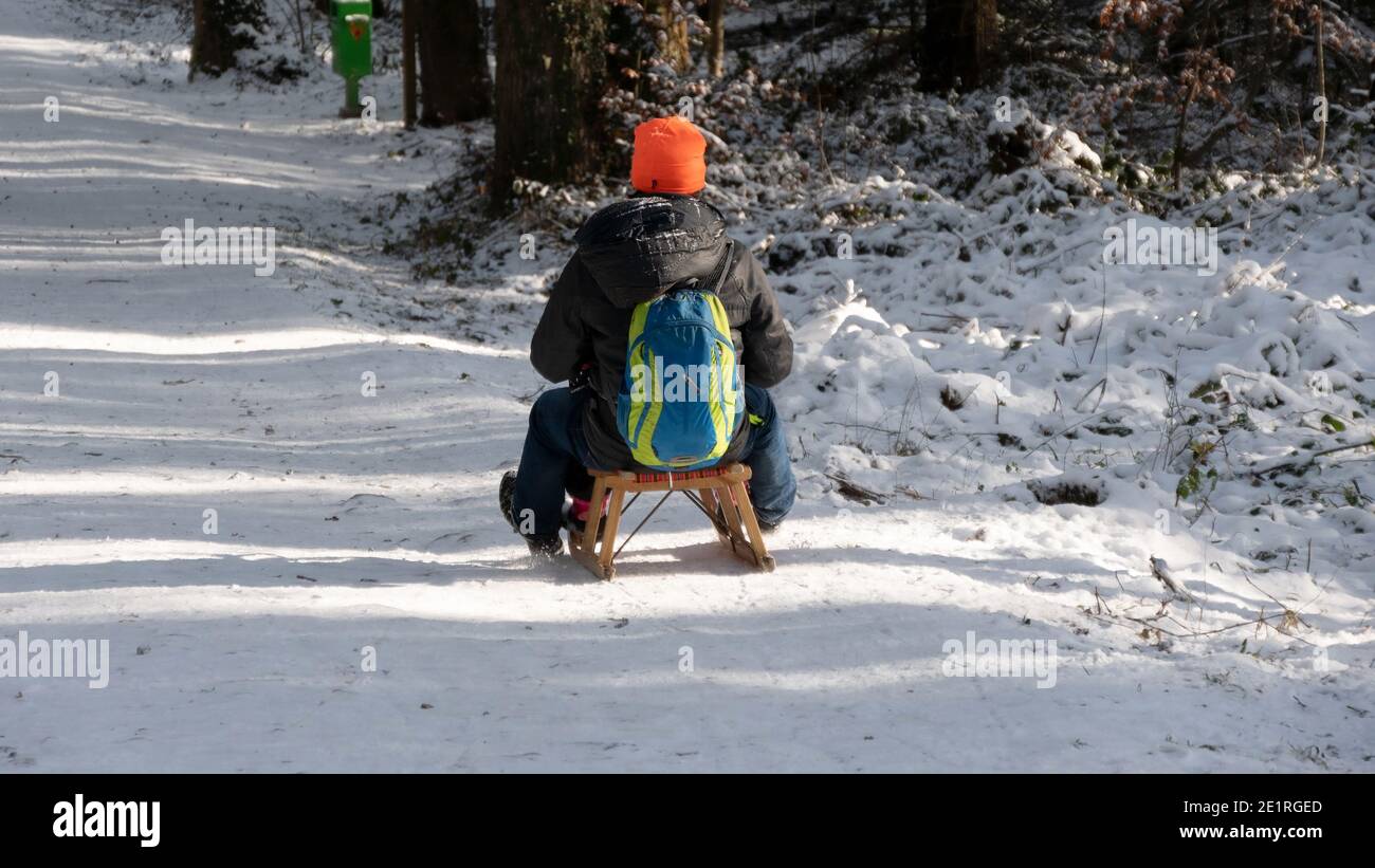 Sledging in the snowy forest on the weekend Stock Photo
