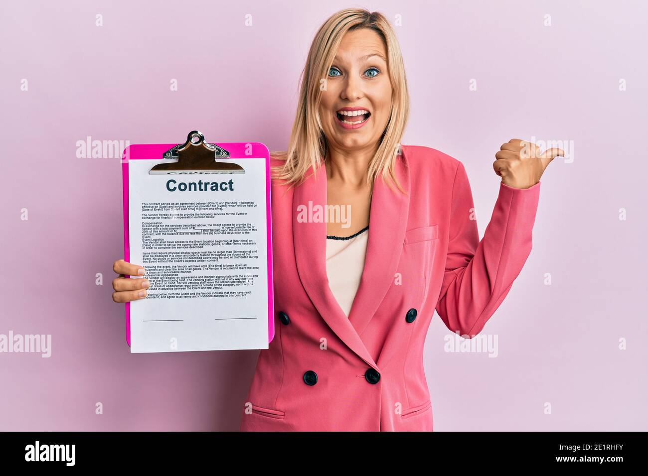 Beautiful middle age blonde woman holding clipboard with contract ...