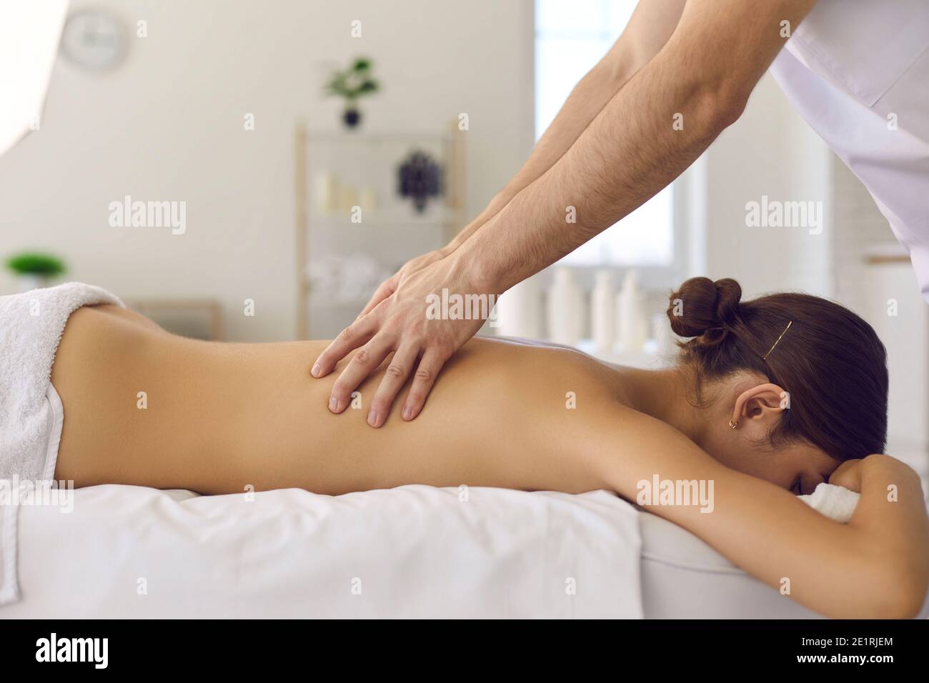 Masseur making acupressure or relaxing massage of back woman Stock Photo