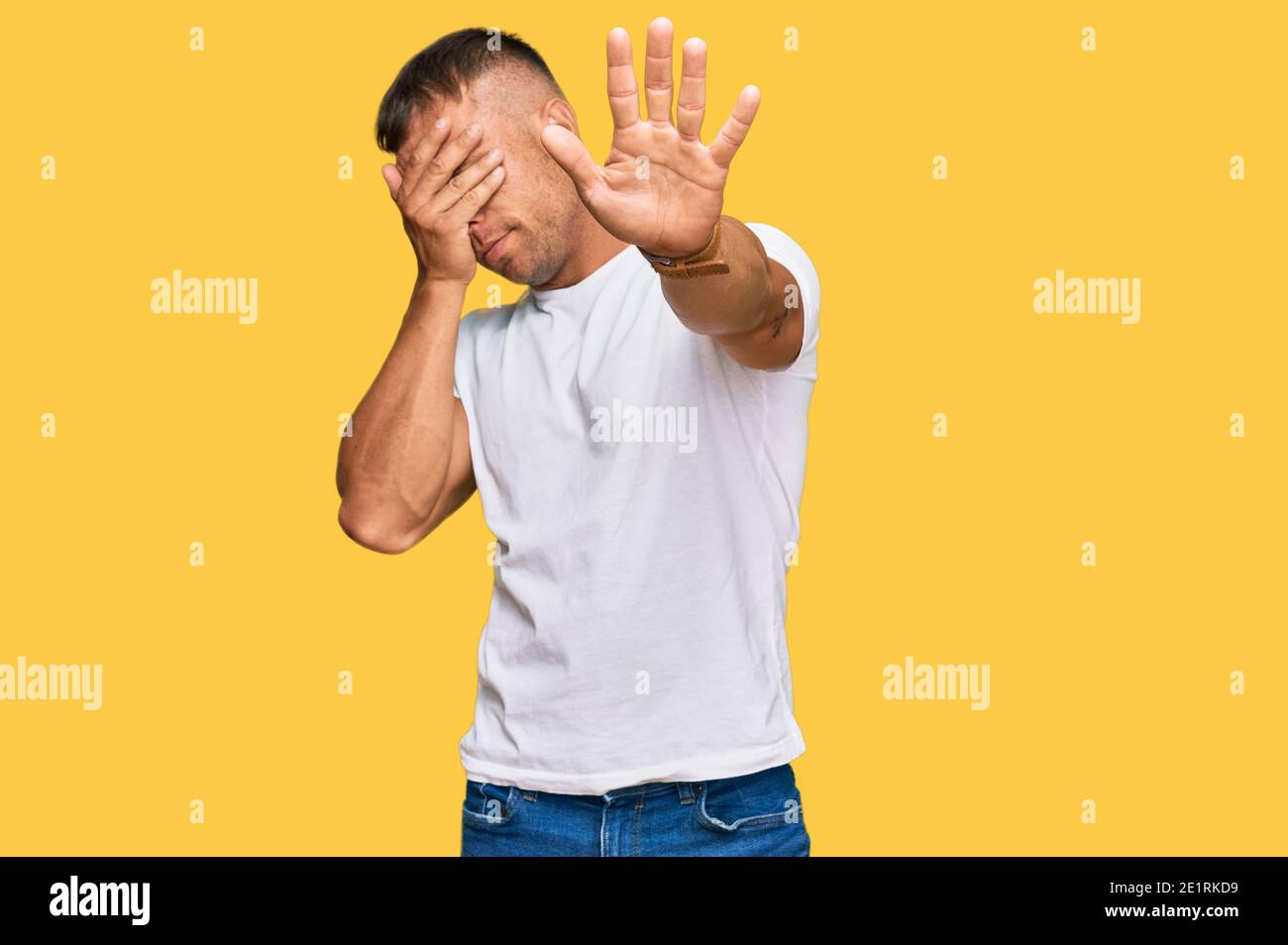 Handsome Muscle Man Wearing Casual White Tshirt Covering Eyes With Hands And Doing Stop Gesture 3214