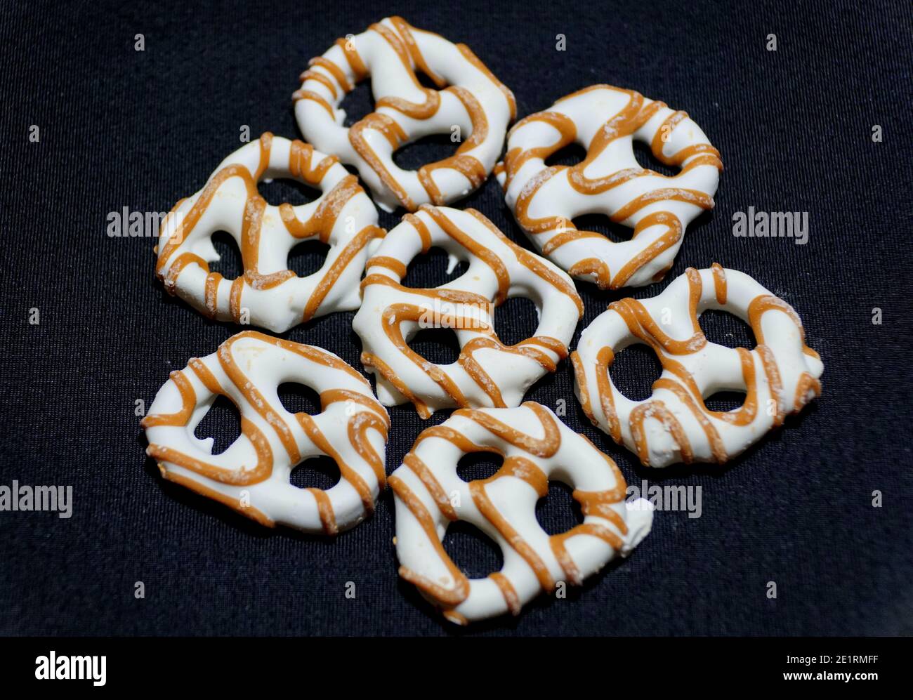 Yogurt pretzels with caramel drizzles on the isolated background Stock Photo