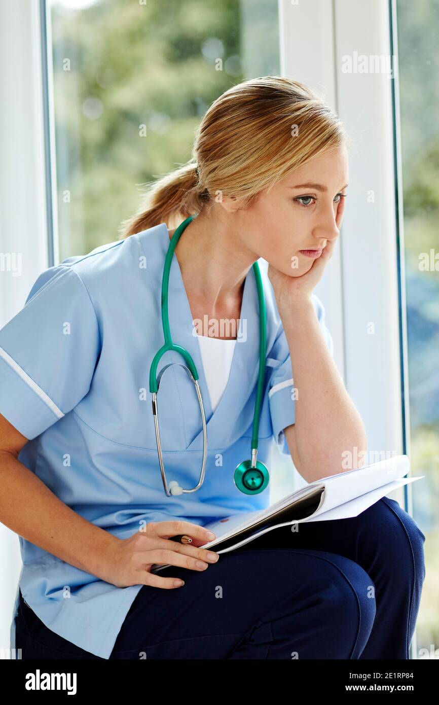 Tired nurse at work Stock Photo - Alamy
