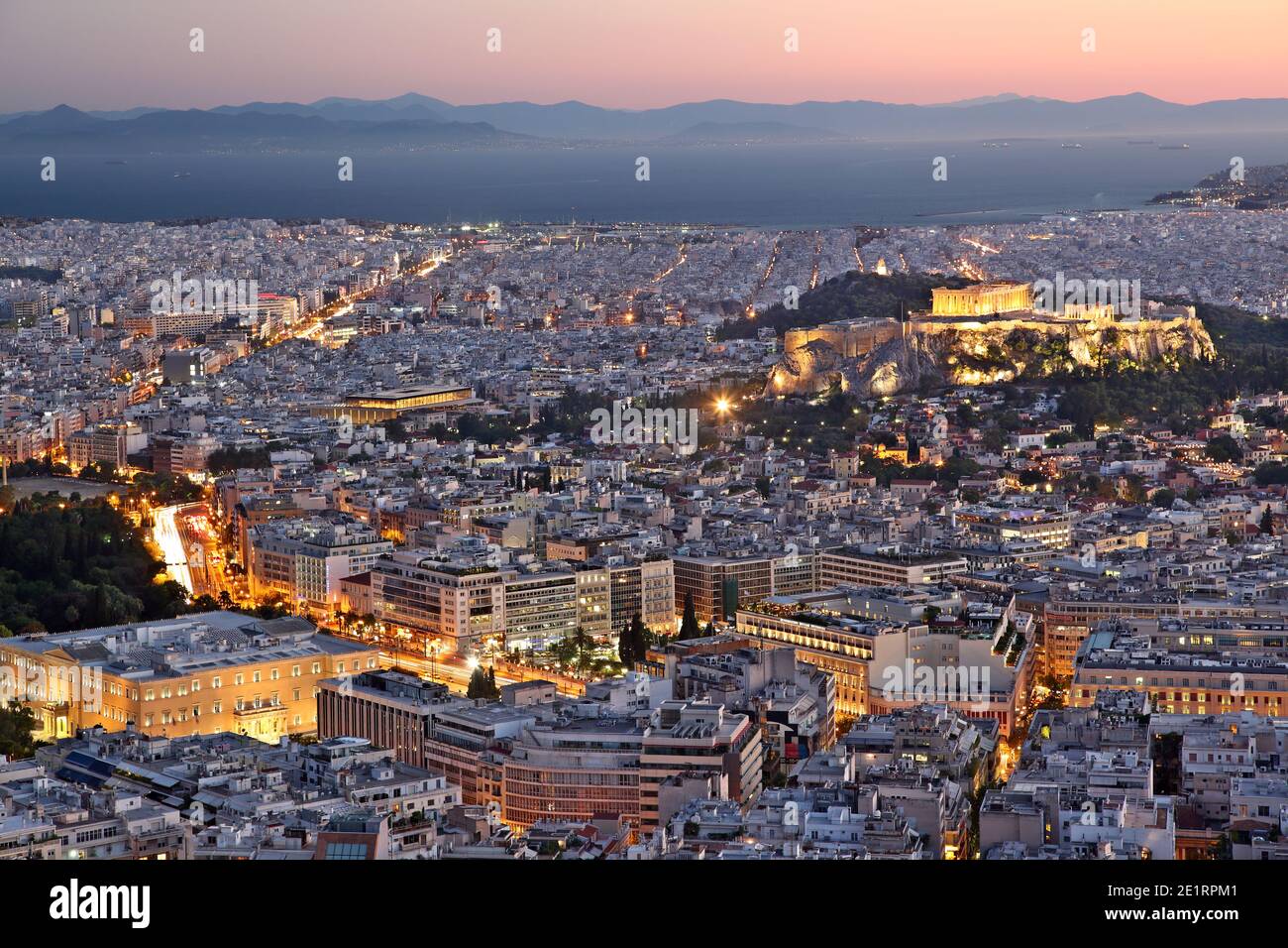View of the city of Athens, during sunset. On the right there can be seen Acropolis and the Parthenon, and on bottom left the Greek Parliament. Stock Photo