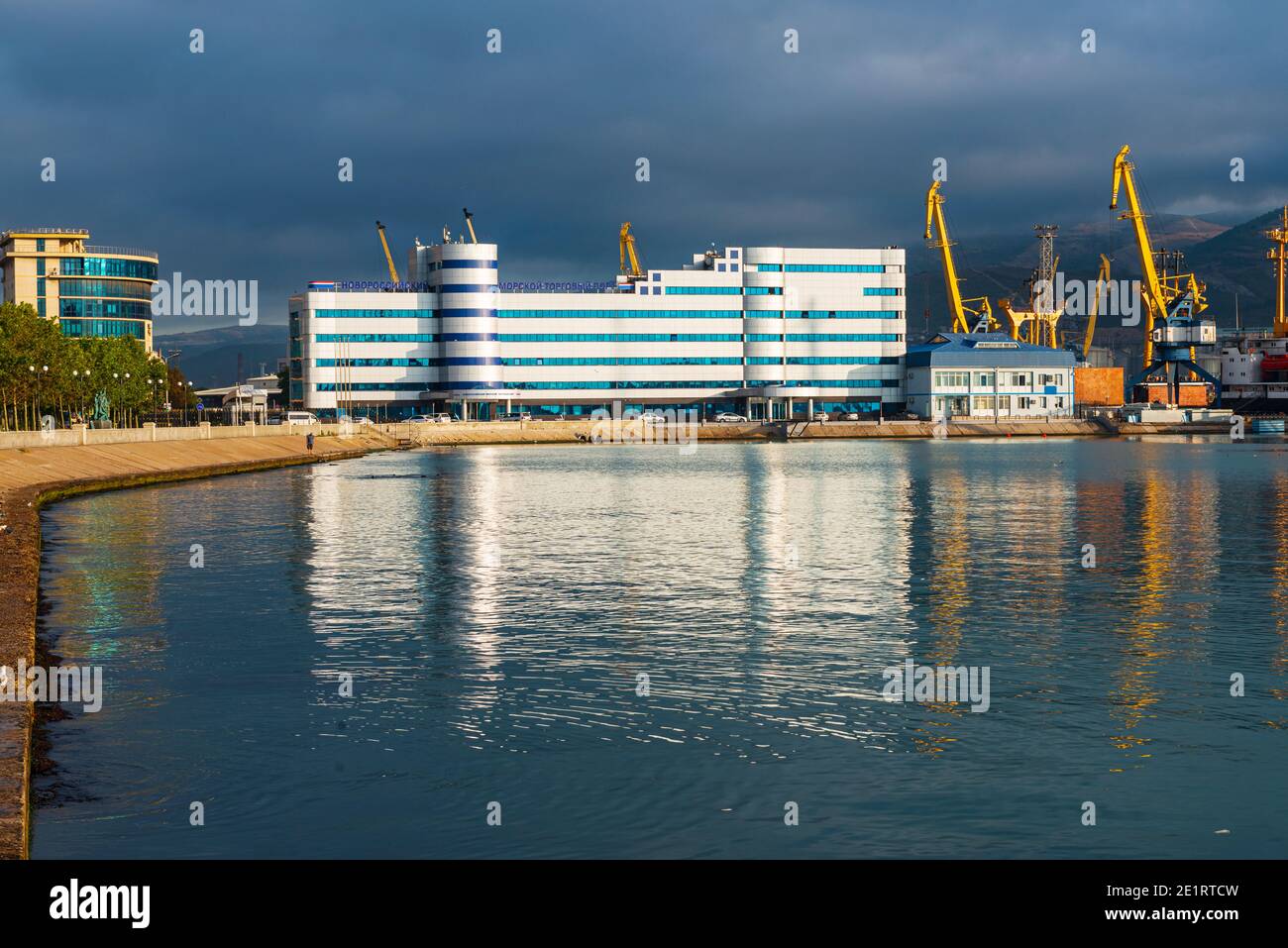 view of the administrative building of the novorossiysk commercial sea port, port facilities and mechanisms, thick fog descends from the mountains Stock Photo