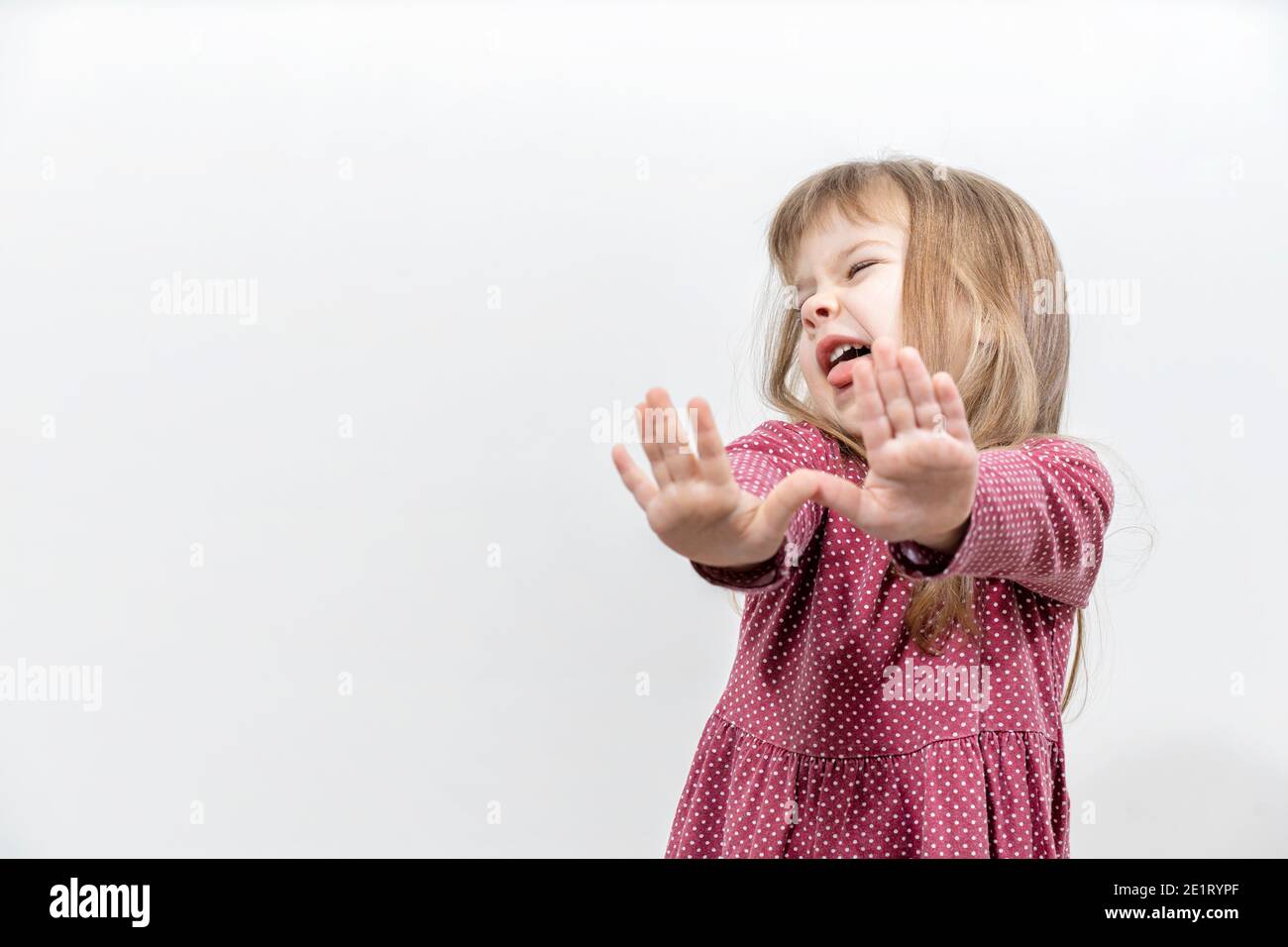 the little girl threw her arms forward in a rejection position. human emotions. mock up with copy space Stock Photo