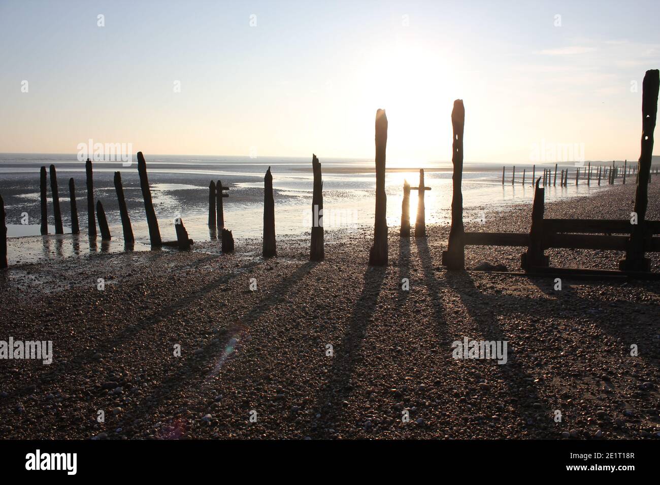 Winchelsea beach landscape view low tide exposing flat sand with wooden