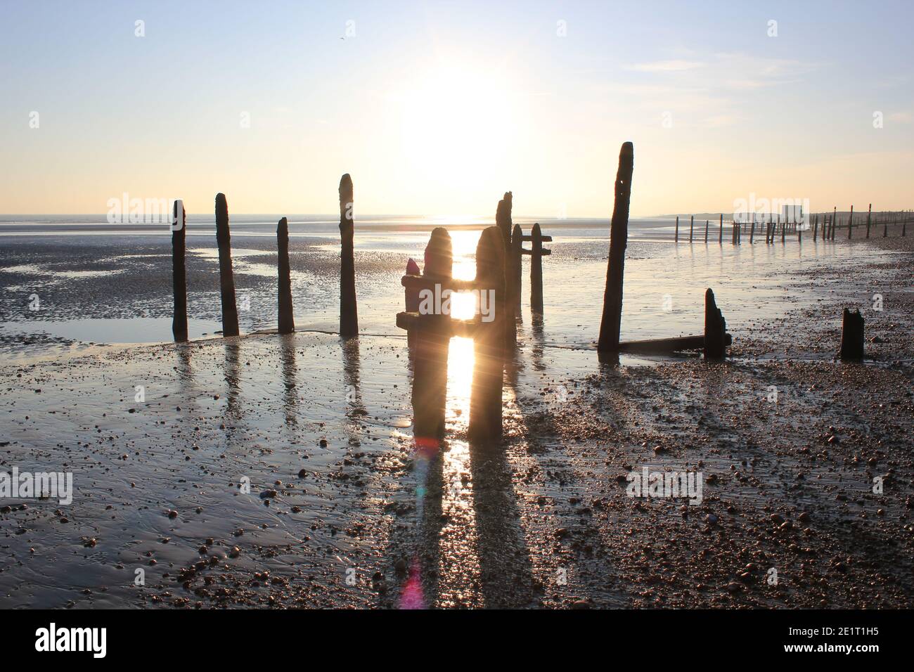 Winchelsea beach landscape view low tide exposing flat sand with wooden