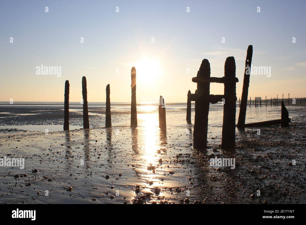 Winchelsea beach landscape view low tide exposing flat sand with wooden