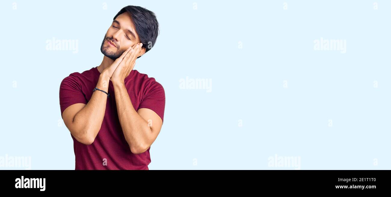 Handsome hispanic man wearing casual clothes sleeping tired dreaming ...