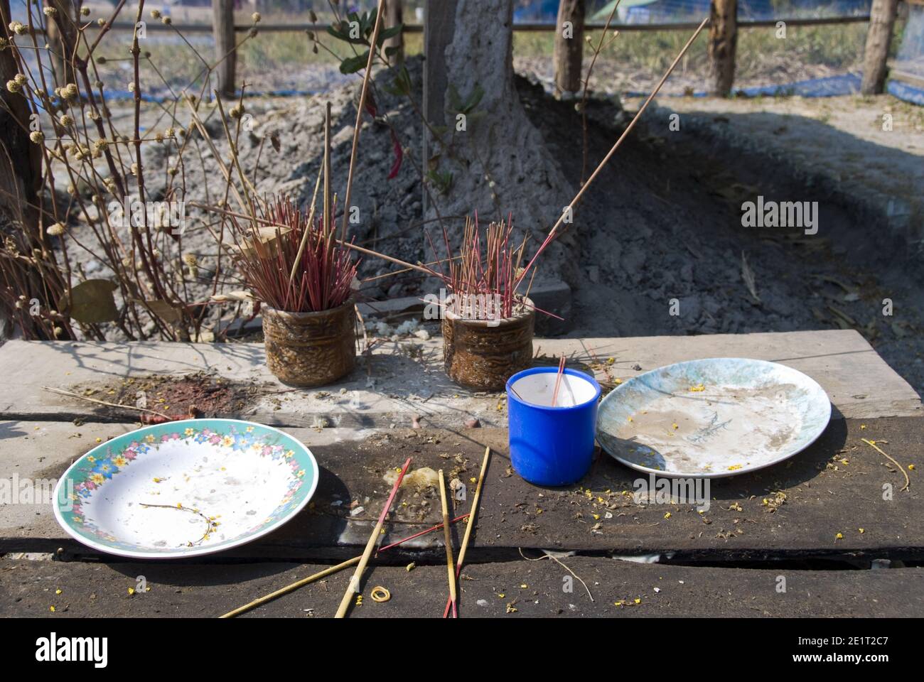 Plates hold offerings and incense sticks at the grave of Cambodian dictator Pol Pot, Khmer Rouge leader from 1963 to 1998 at Anlong Veng, Cambodia. Stock Photo