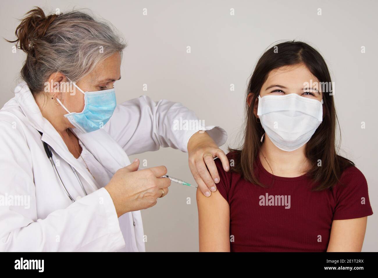 Teenager girl being vaccinated COVID concept Stock Photo