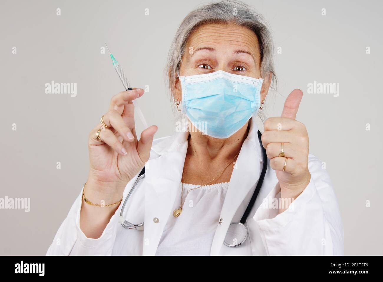 Relieved healthcare worker doctor or nurse with COVID vaccine concept Stock Photo