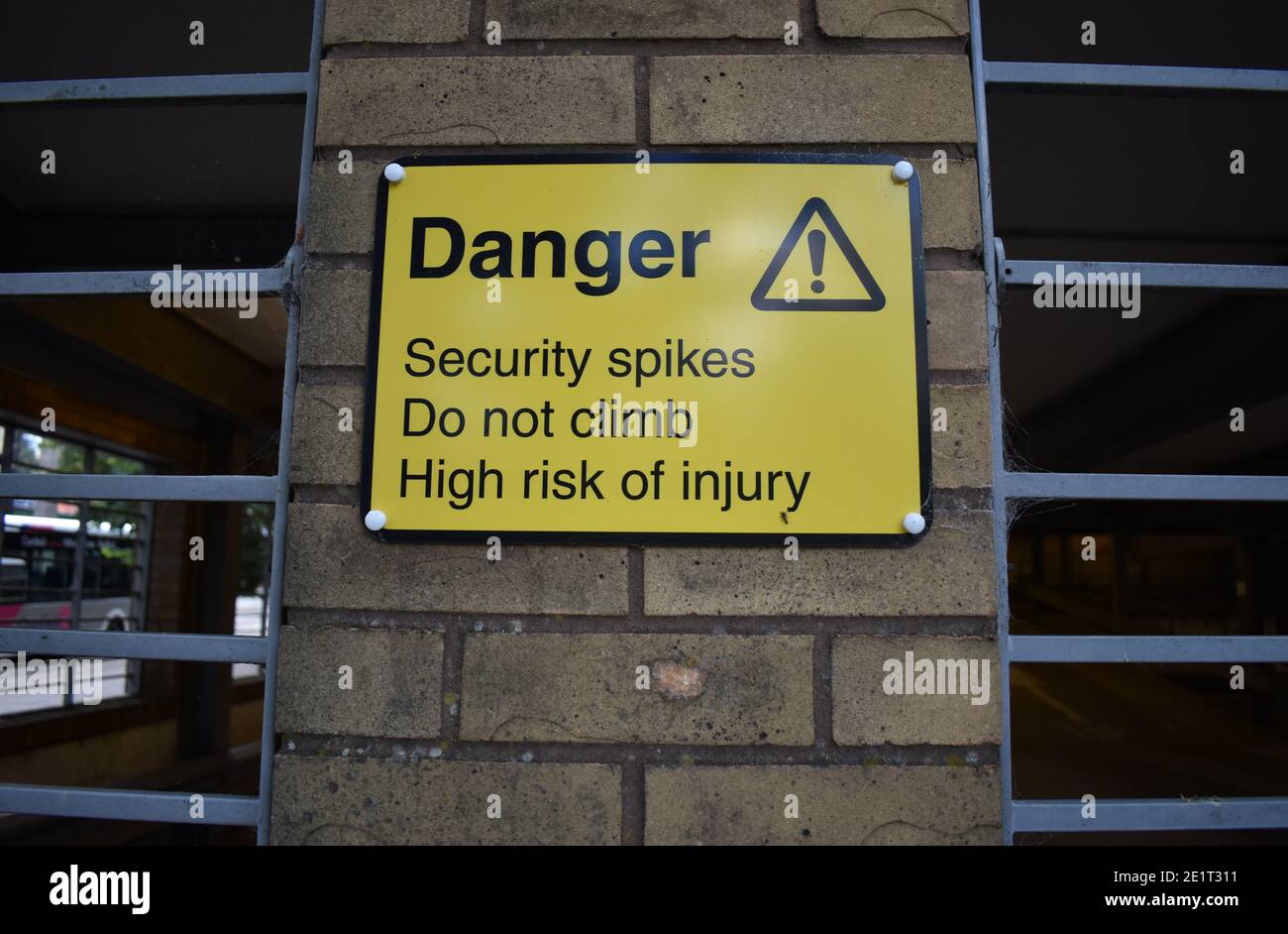 Sign - Danger, Security spikes, Do not climb Stock Photo