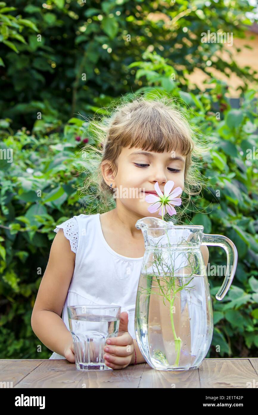 The child drinks clean water in summer. Selective focus. People Stock