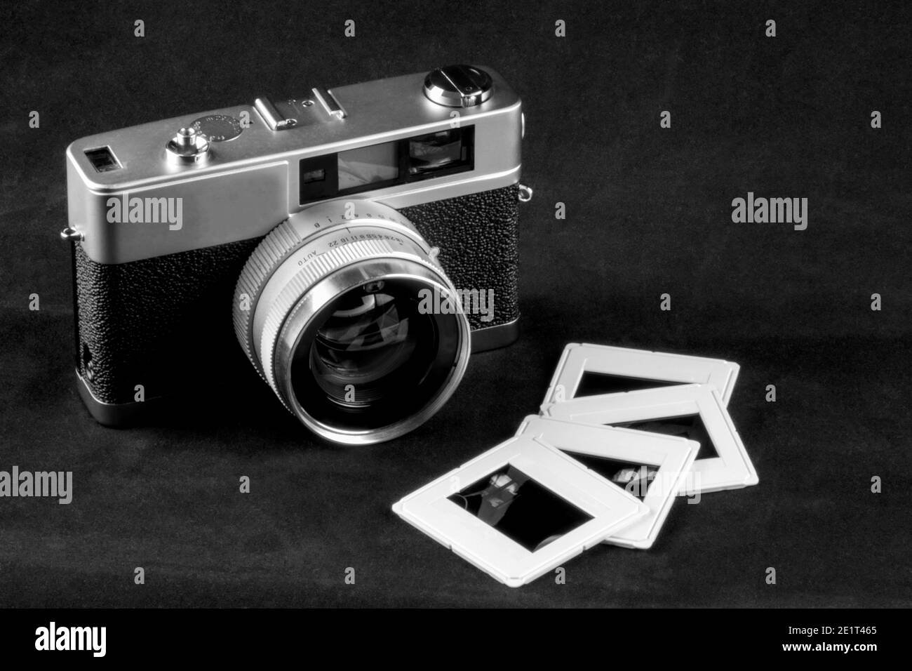 Obsolete film camera with mounted slides monochrome Stock Photo