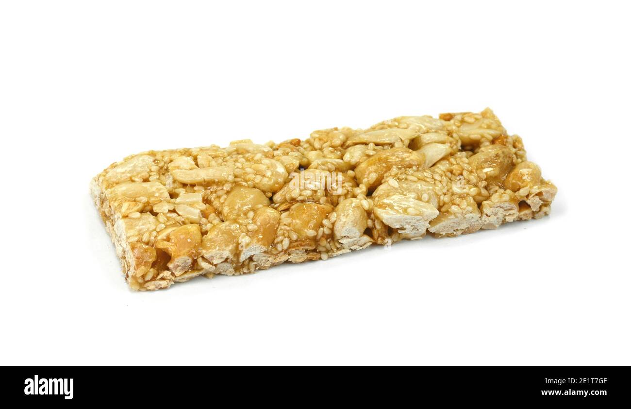 Honey bars with peanuts, sesame and sunflower seeds isolated. Peanut and sesame brittle on white