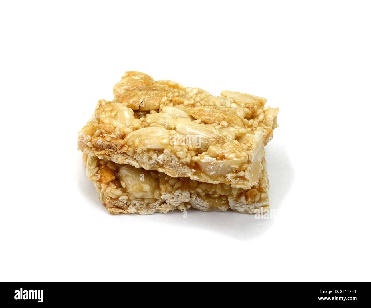 Honey bars with peanuts, sesame and sunflower seeds isolated. Peanut and sesame brittle on white