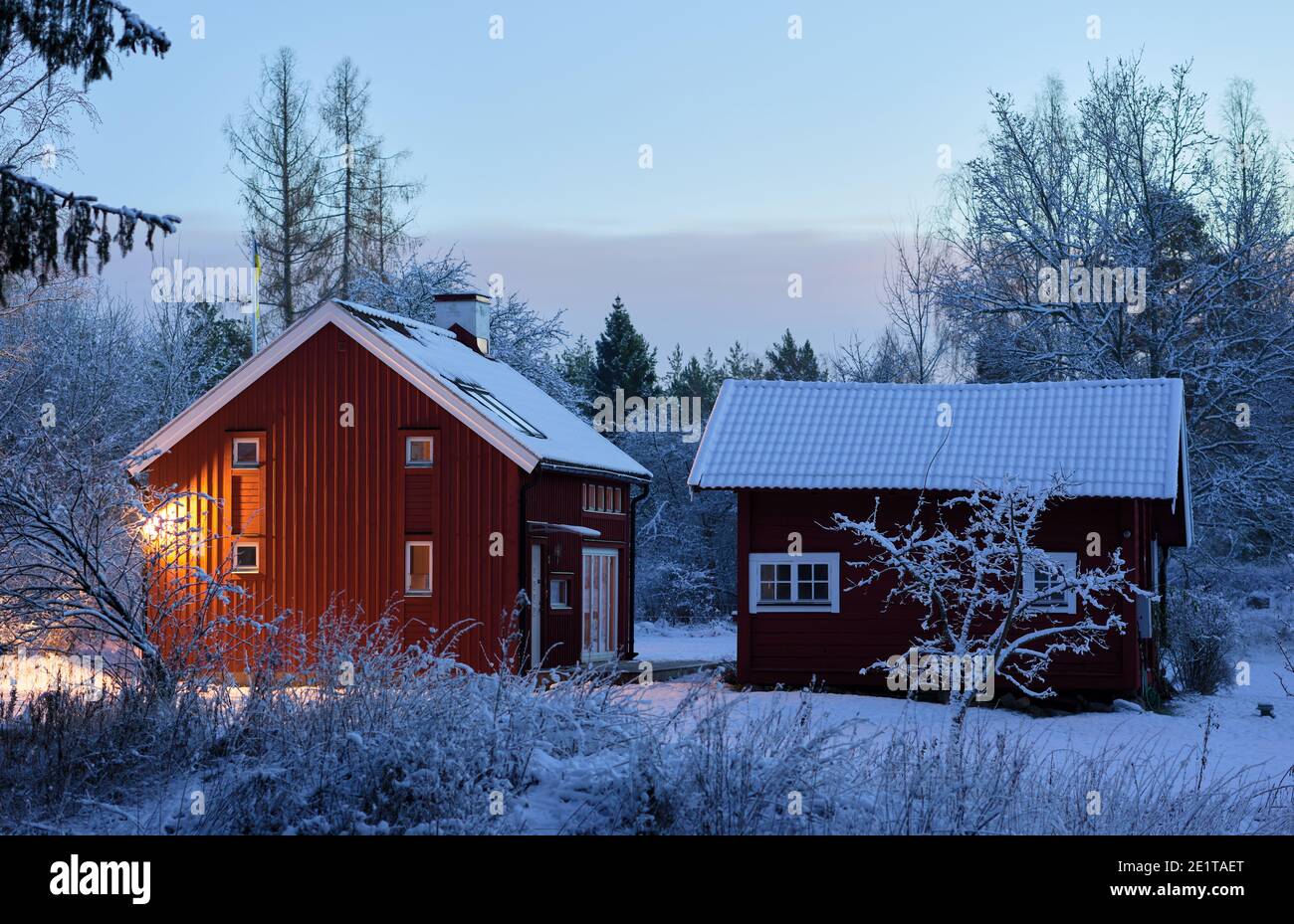 House in Sandvreten, Bogesundslandet, outside Vaxholm, Sweden, during a winter evening Stock Photo