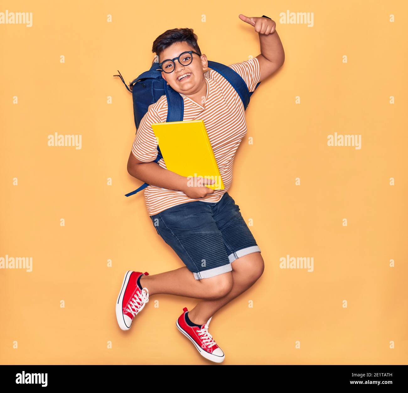 Adorable student boy wearing glasses and backpack smiling happy ...
