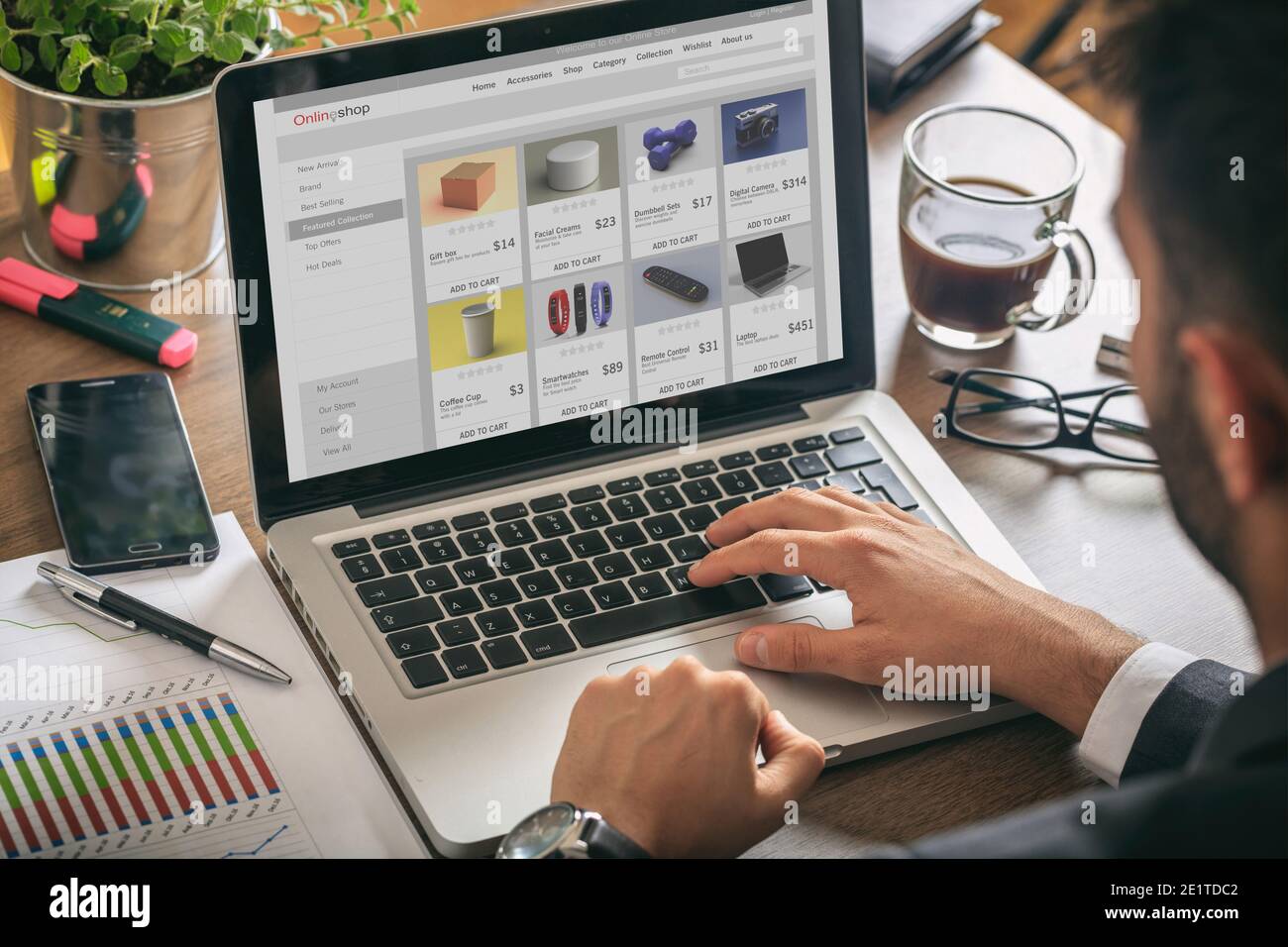 Online shop website developer, Man working with a computer laptop, eshop web page on the screen, office desk background. Stock Photo