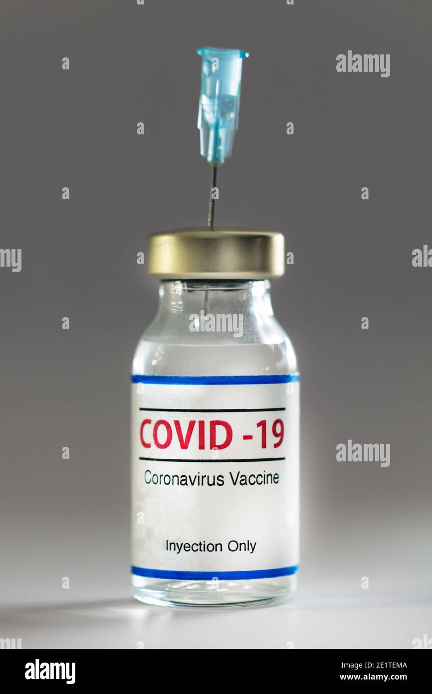 Bottle of coronavirus vaccine with a needle inside, isolated Stock Photo