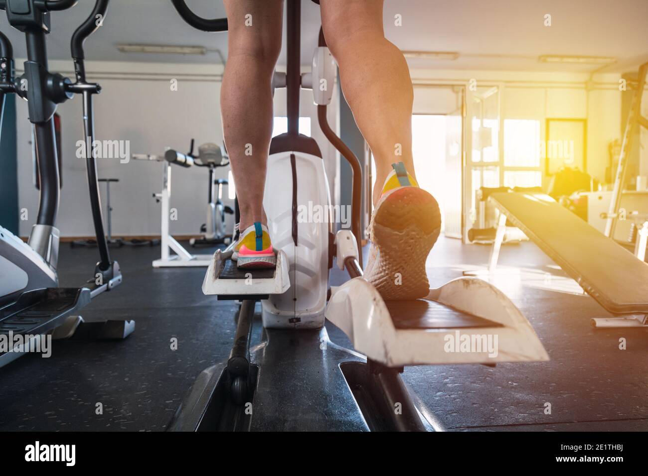 Young male using elliptical.Concept of health and well-being. Stock Photo