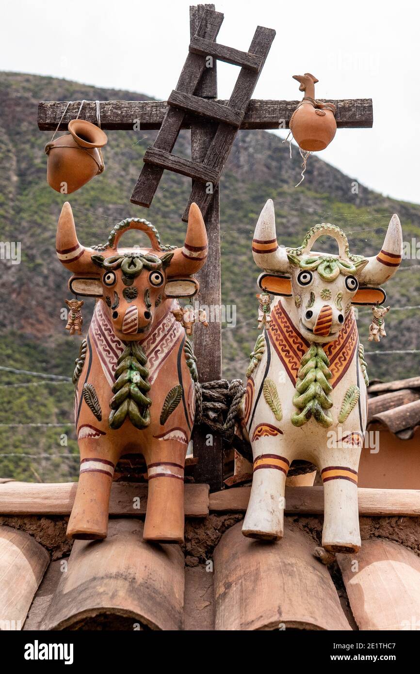 Rooftop decorations in Chinchero in the Sacred Valley of the Peruvian Andes are supposed to bring good fortune to households Stock Photo