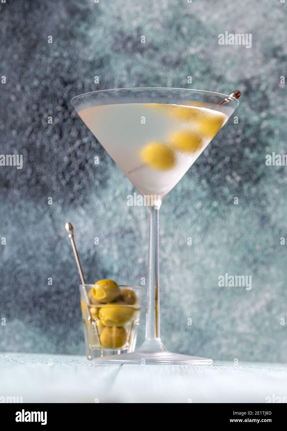 Glass of Dry Martini with green olives Stock Photo Alamy
