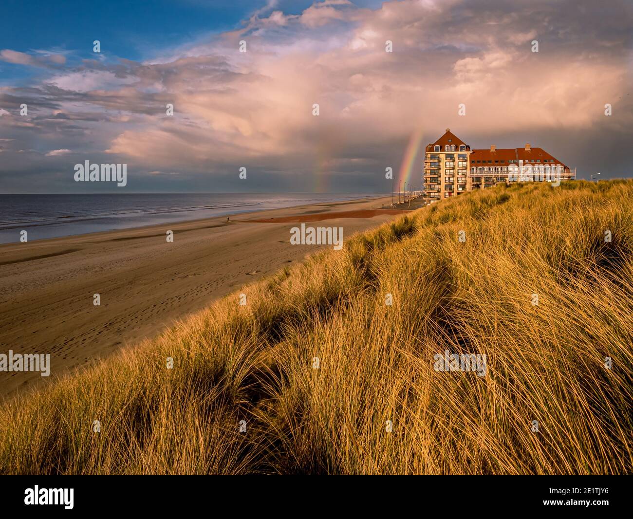 Rainbow at dramatic sky at the beach Stock Photo
