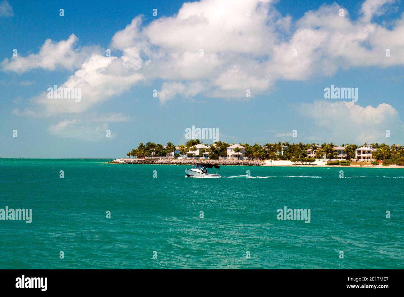 Small motorboat on tropical blue waters of the Sunset Key resort island in the city of Key West Stock Photo