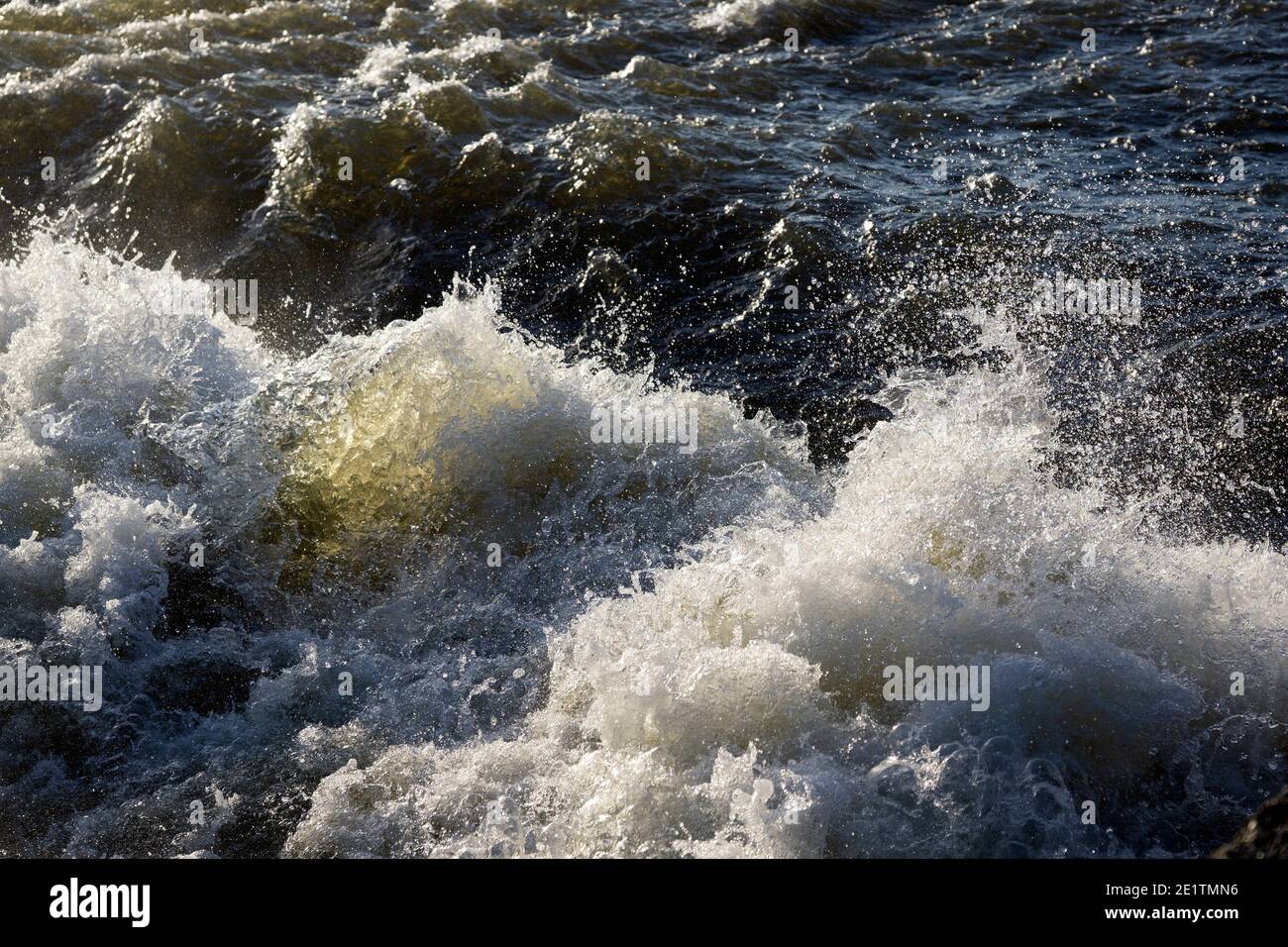 Gushing water flowing over a river weir Stock Photo Alamy