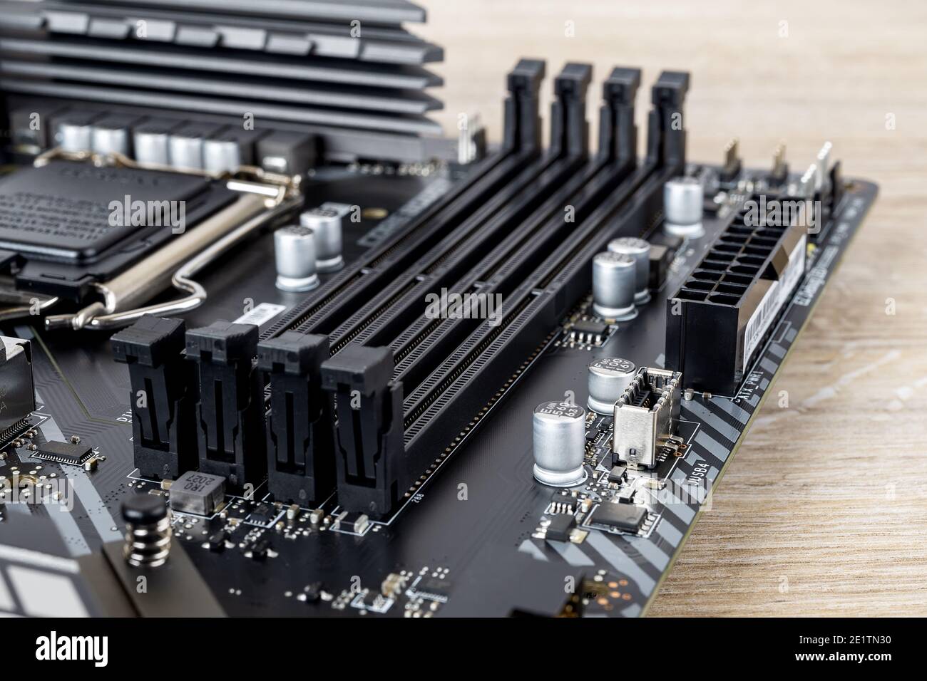 Four slots for ddr4 ram memory modules on a modern black pc motherboard. Computer mainboard circuit components. Desktop hardware close-up. Stock Photo