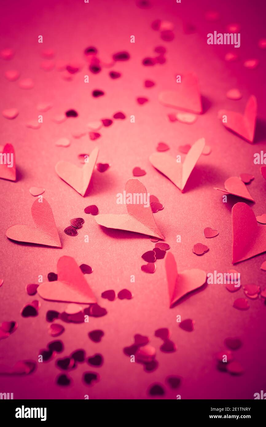Red paper hearts on red background as background. Concept of love and ...