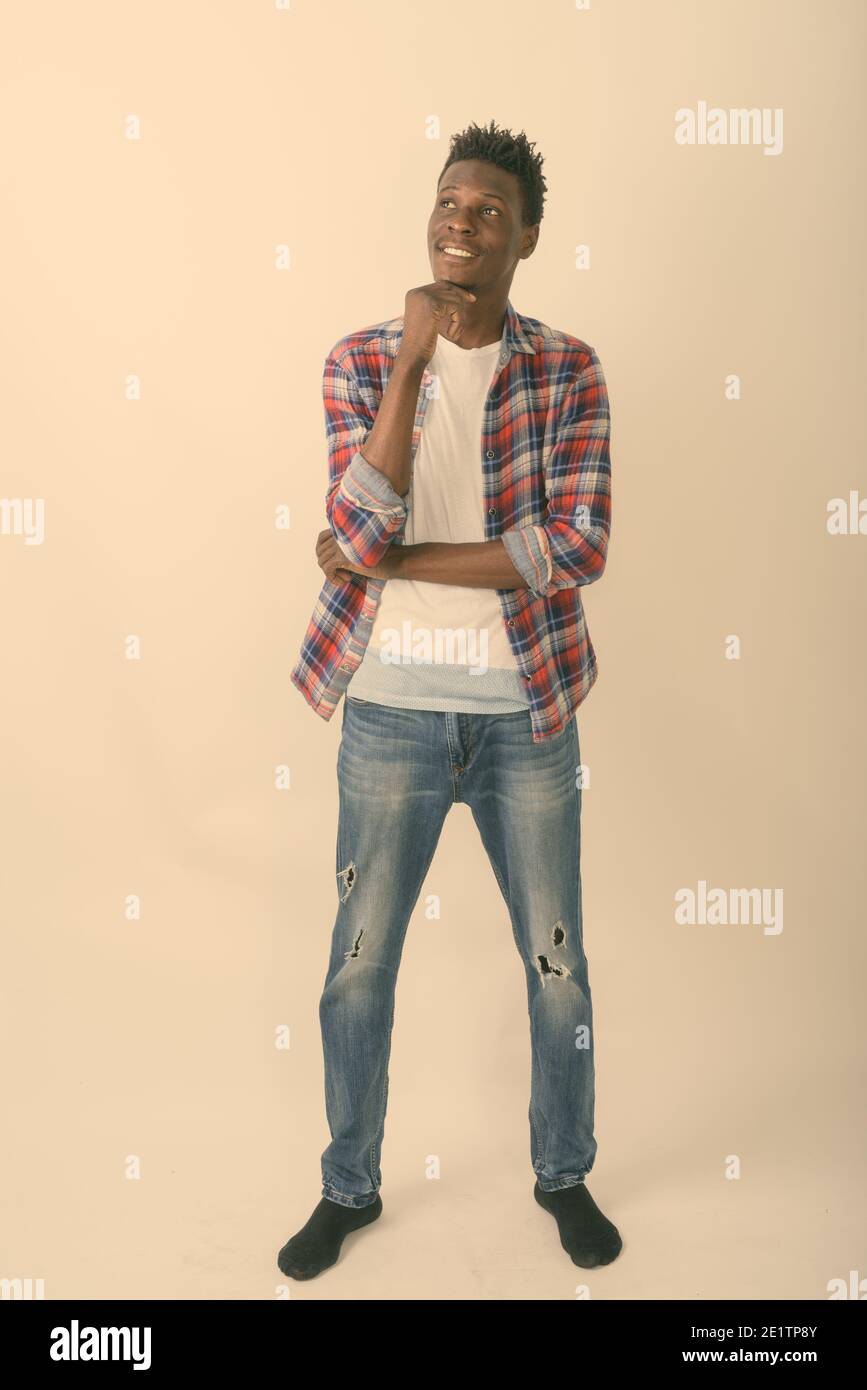 Full body shot of young happy black African man smiling and standing ...