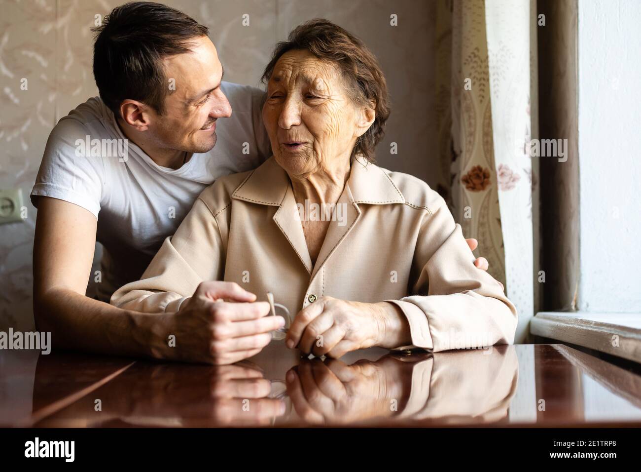 a very old woman and an adult grandson Stock Photo