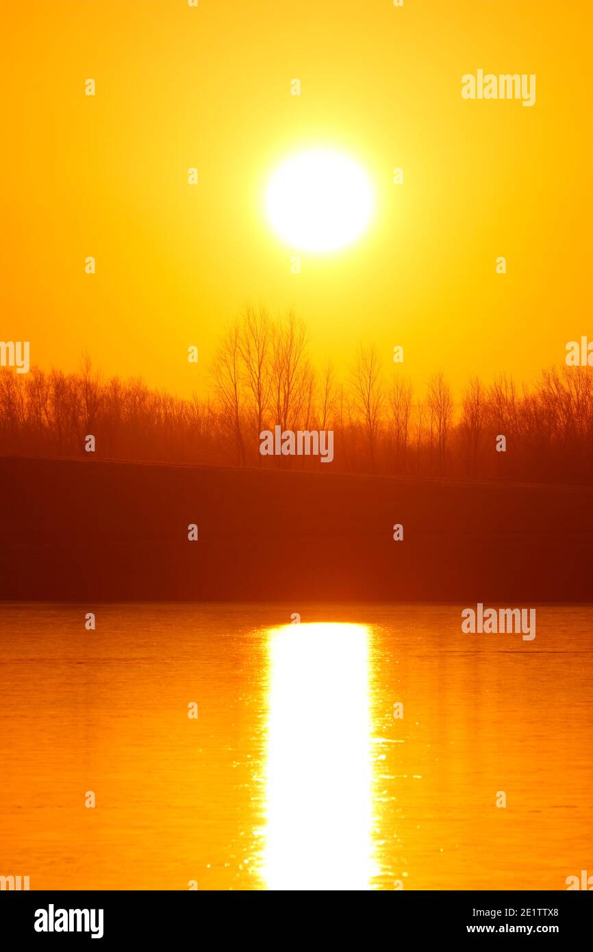 Sunrise over a frozen Bowers Lake at St Aidan's Nature Park in