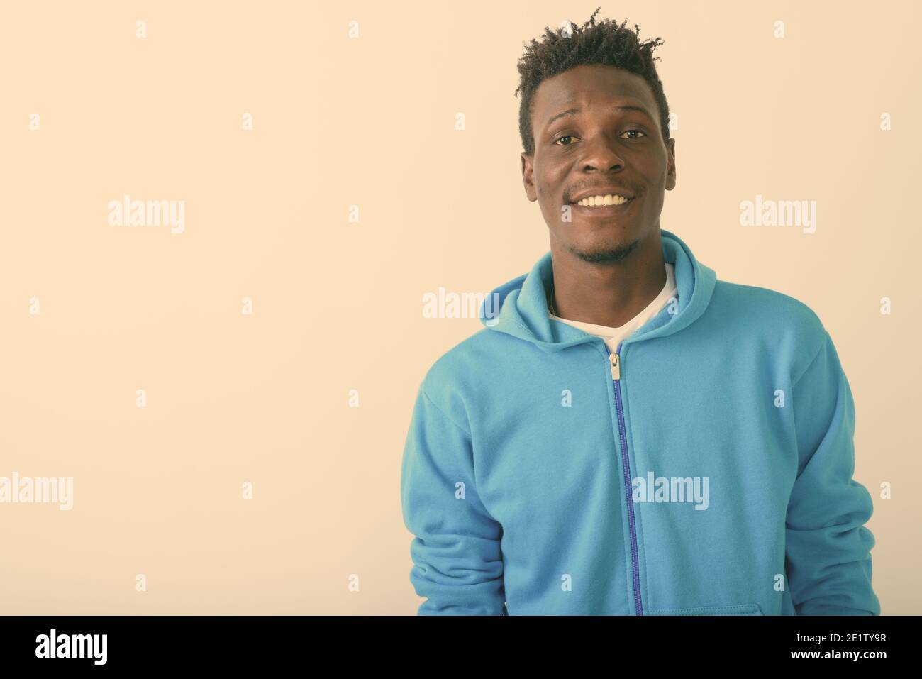 Close up of young happy black African man smiling against white background Stock Photo