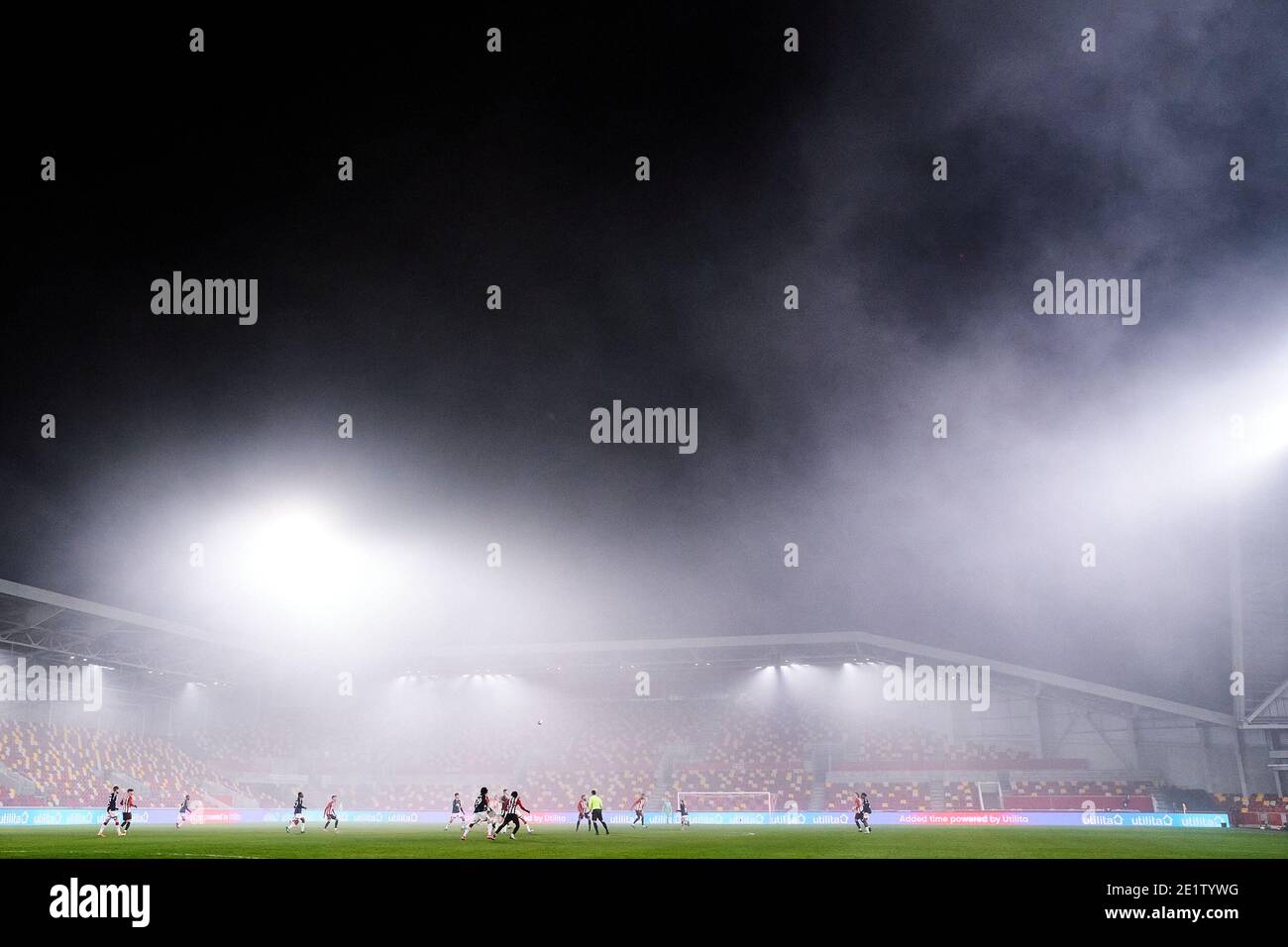 General view of the action between Brentford and Middlesbrough in foggy conditions, during the Emirates FA Cup third round match at the Brentford Community Stadium, London. Stock Photo