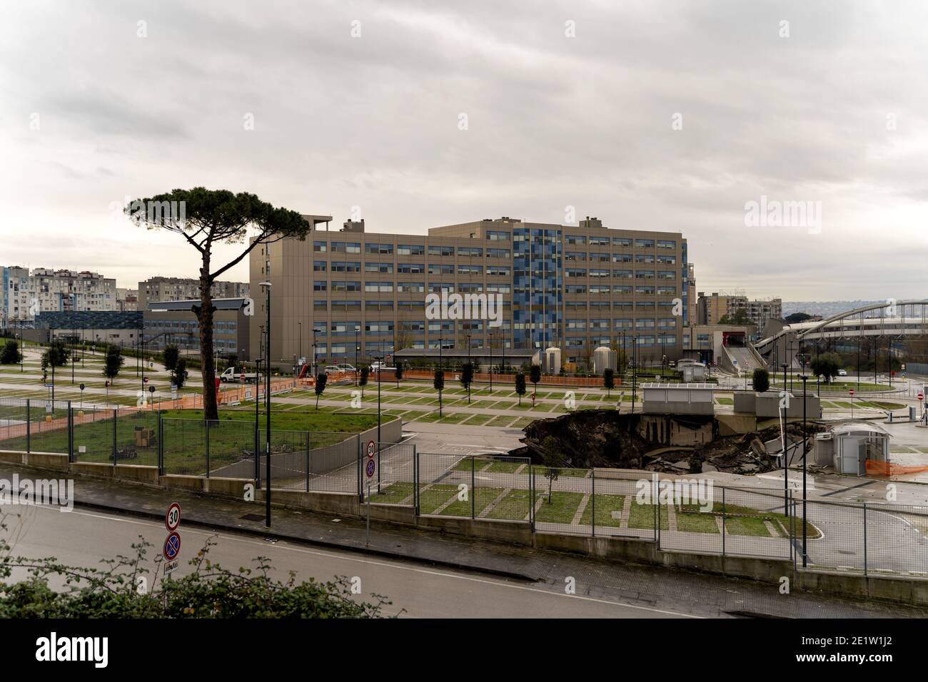 Naples, Italy. 09th Jan, 2021. A large chasm has opened in the parking lot of the Ospedale del Mare, on the eastern outskirts of Naples. It could be due to a failure caused by infiltrations. It is about twenty meters deep and about 2000 square meters wide, the area is under criminal seizure, the fact happened at dawn yesterday 08 January 2021. (Photo by Alessandro Barone/Pacific Press) Credit: Pacific Press Media Production Corp./Alamy Live News Stock Photo