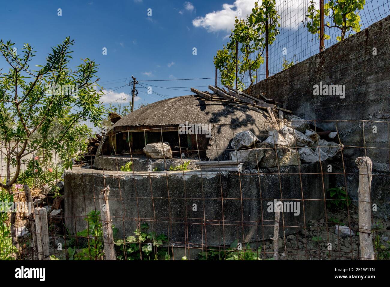Abandoned concrete bunker repurposed as a doghouse near Tirana, Albania. Communist-era bunkers built by dictator Enver Hoxha during the Cold War Stock Photo