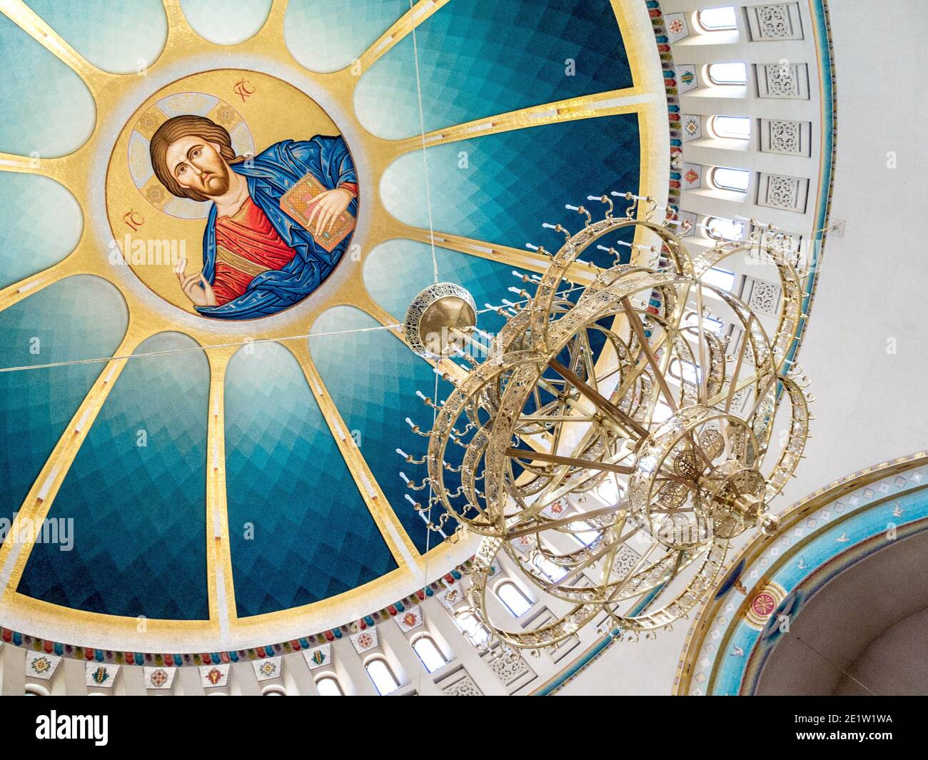 Ceiling painting of Jesus and large chandelier inside the Resurrection Cathedral, an Albanian Orthodox Church built in 2014 in Tirana, Albania Stock Photo