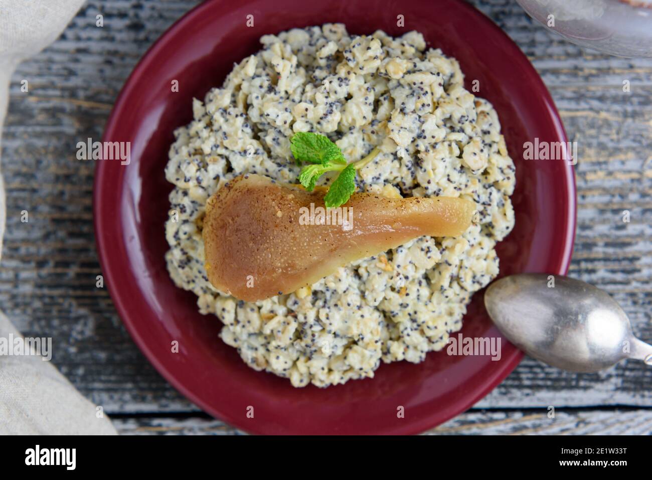 Poppy seed porridge with orange peel and pears, flat lay close-up Stock Photo