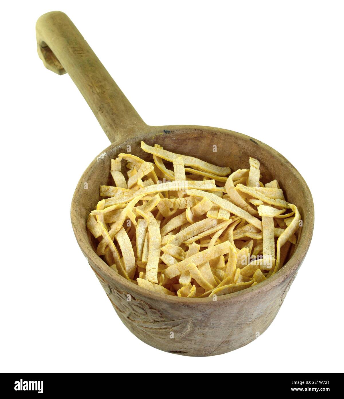 Fresh homemade fettuccine pasta noodles in a wooden bowl isolated on