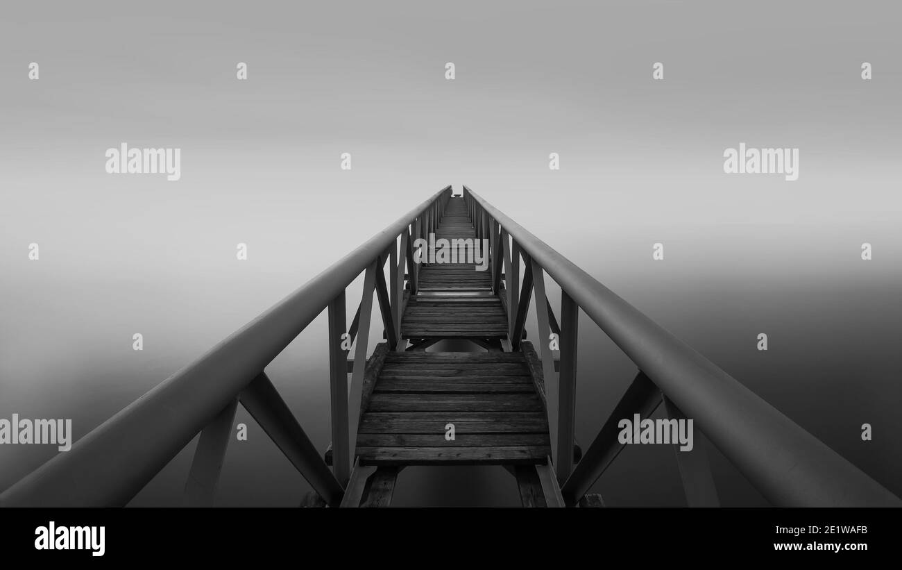 A long and narrow pier. Long exposure fine art minimalistic black and
